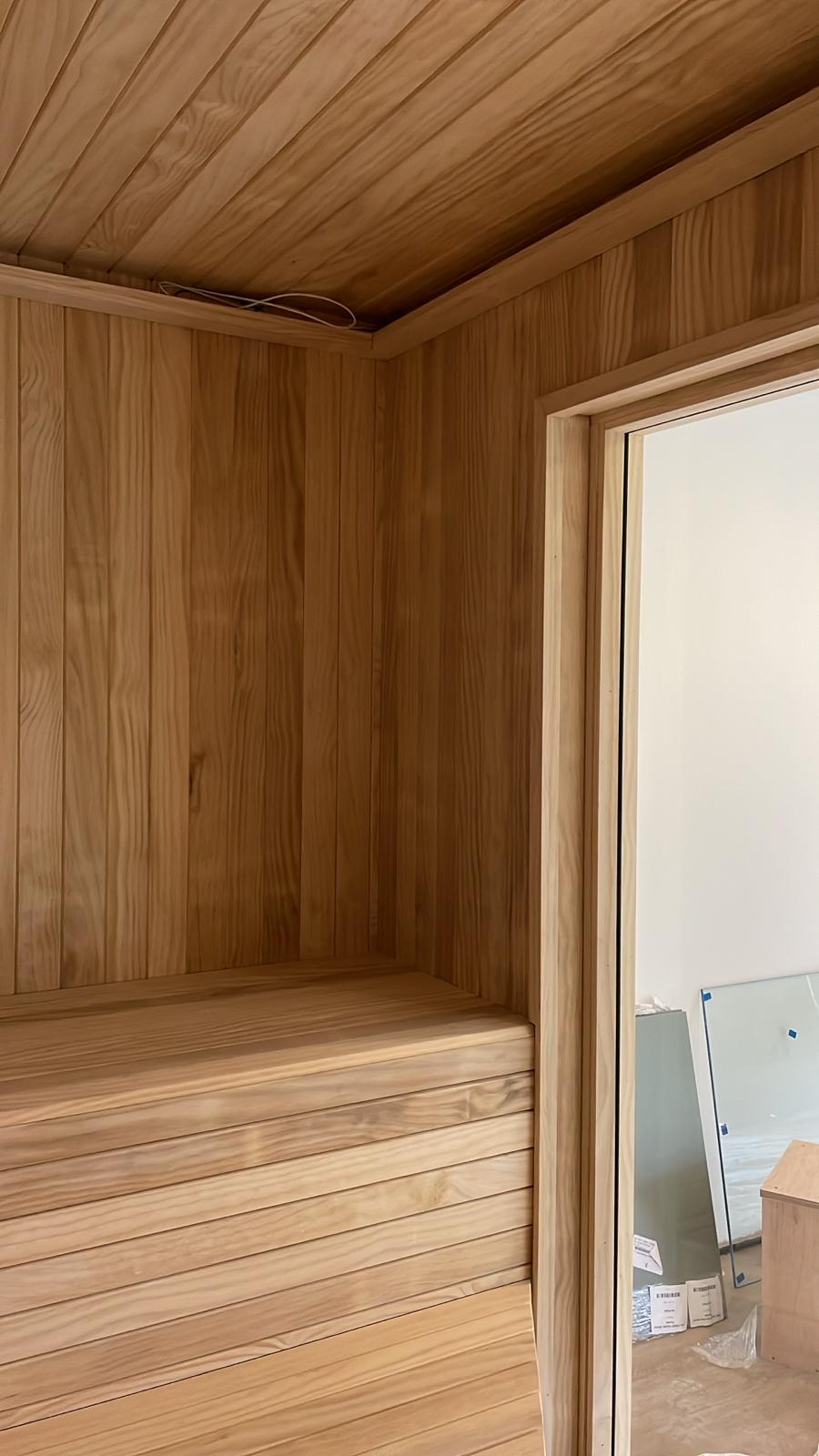 Detailed timber wall and ceiling panelling around an internal opening