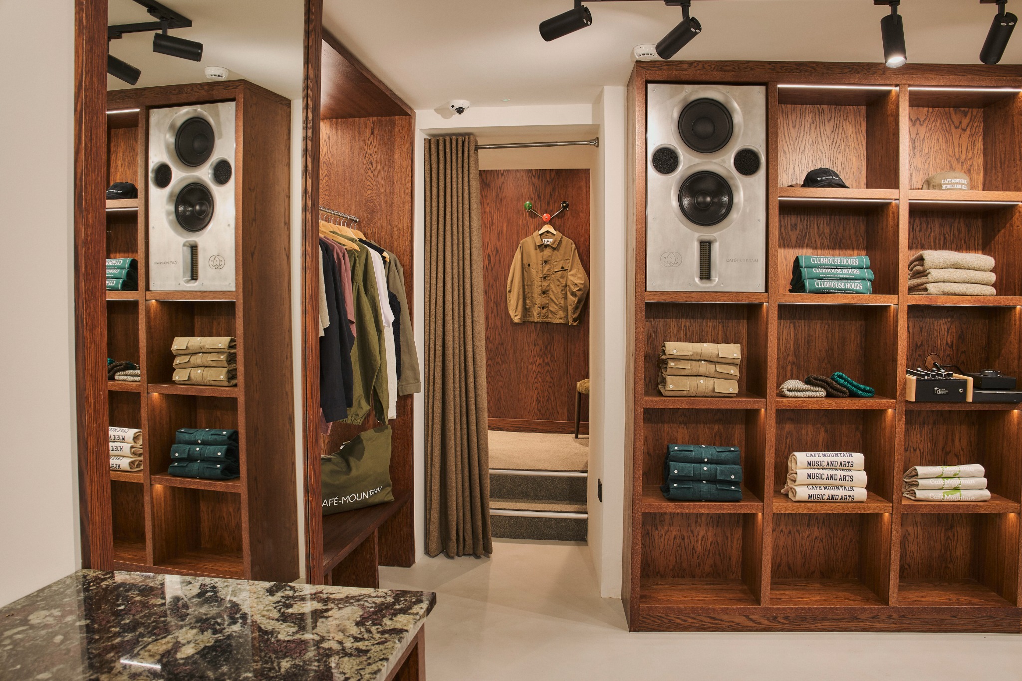 Tall illuminated retail display units with integrated speaker features