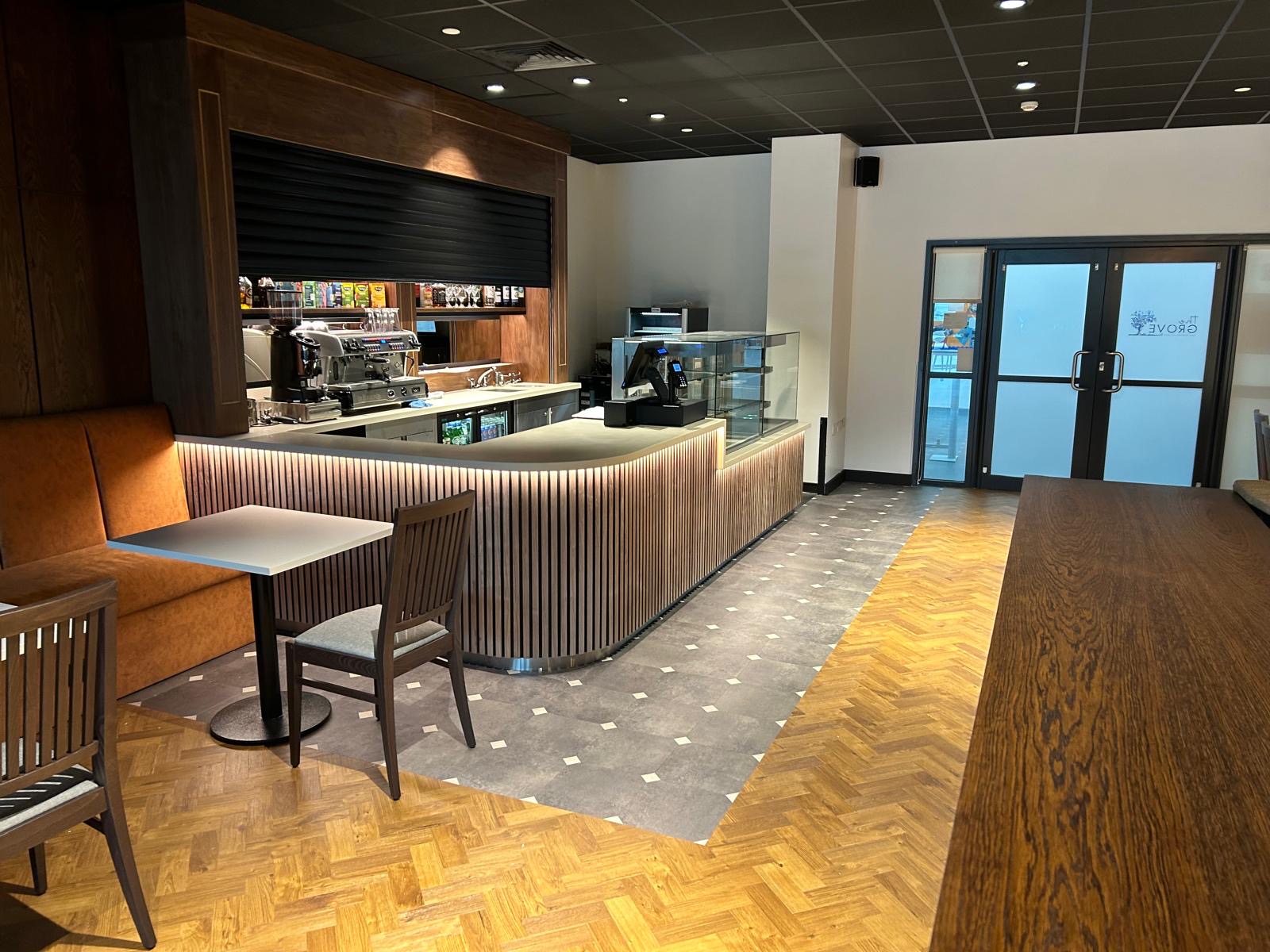 Completed curved timber counter with integrated lighting in a hospitality interior