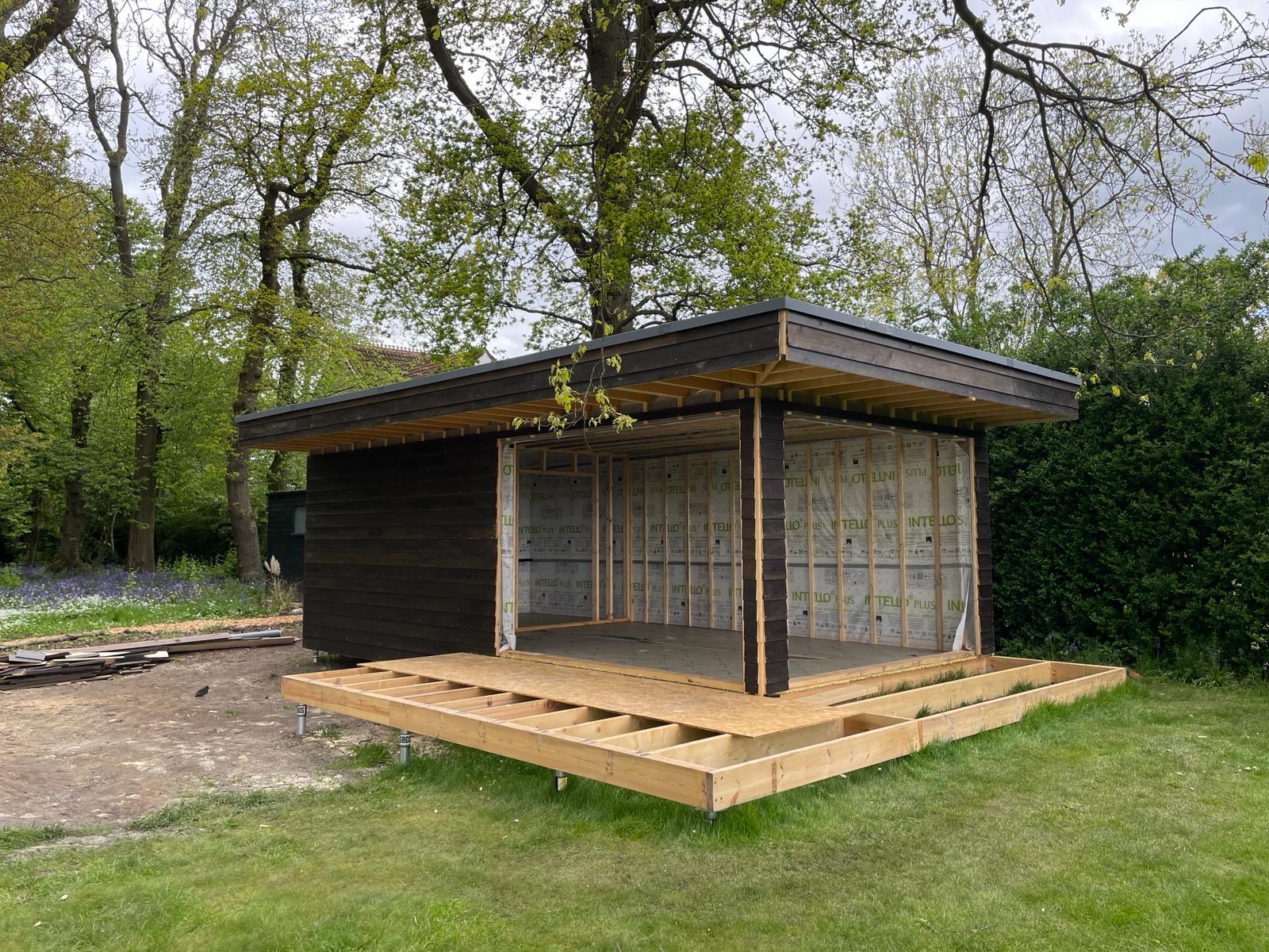 Contemporary timber garden room taking shape in a woodland setting